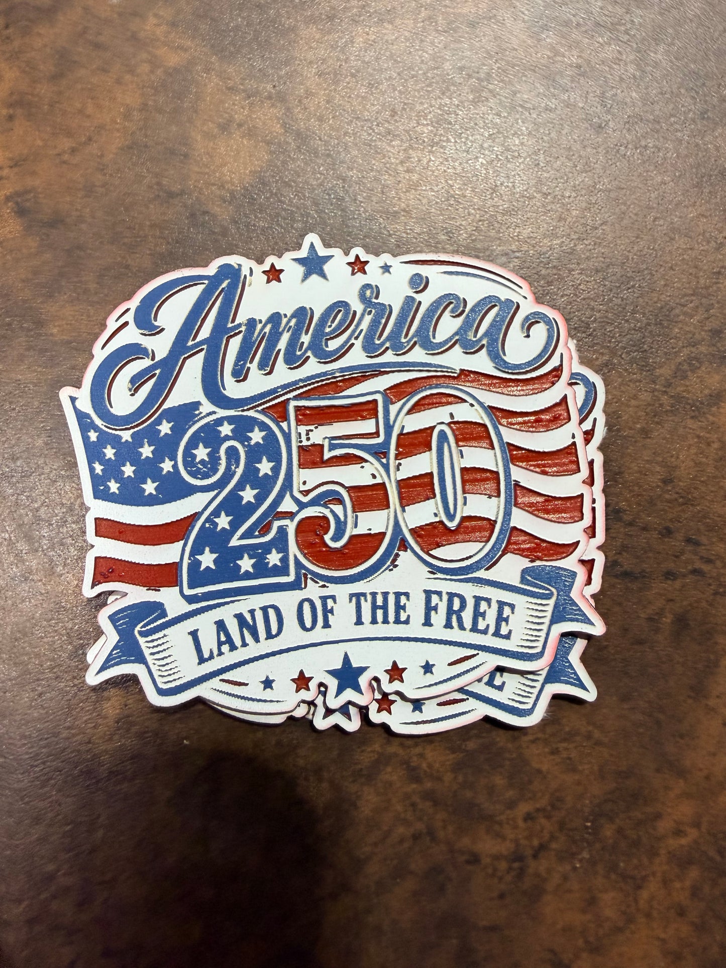 The America 250 Acrylic Patch by DB Custom Creations features red, white, and blue stars and stripes with "Land of the Free," celebrating the U.S. 250th anniversary. Strong adhesive ensures lasting hold on any brown surface.