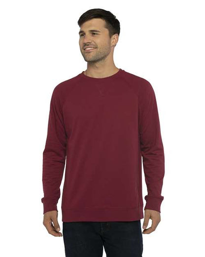 A man with short brown hair is standing and smiling, wearing the Next Level 9000 maroon v-notch neck long-sleeve sweatshirt made from cotton polyester fleece and dark jeans against a white background.