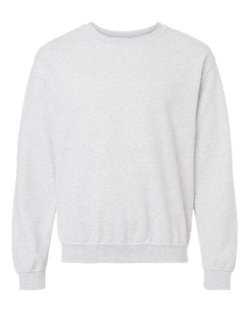 The Gildan 18000 is a plain light gray Heavy Blend sweatshirt with long sleeves, ribbed cuffs, and waistband, made sustainably and shown on a white background.