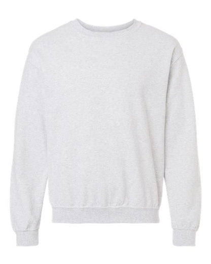 The Gildan 18000 is a plain light gray Heavy Blend sweatshirt with long sleeves, ribbed cuffs, and waistband, made sustainably and shown on a white background.