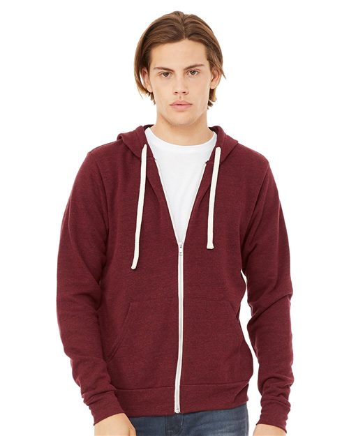 A young person with straight, light brown hair wears a maroon BELLA + CANVAS 3909 polyester fleece hoodie with white drawstrings over a white t-shirt, standing against a plain background and looking at the camera neutrally.