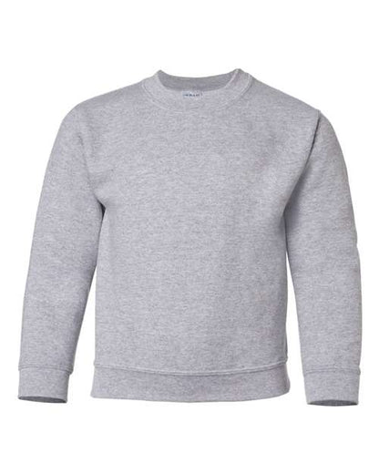 The Gildan 18000B is a plain, light gray crewneck sweatshirt with long sleeves and ribbed cuffs, collar, and waistband, made from Heavy Blend fabric and shown against a white background.