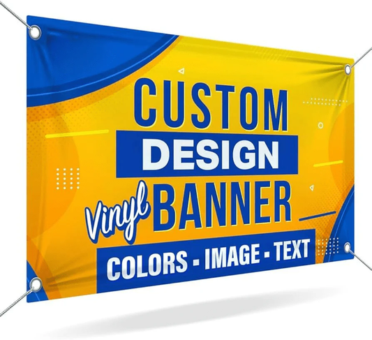 A rectangular yellow and blue vinyl Custom Banner from DB Custom Creations hangs by cords at each corner, displaying “Custom Design Vinyl Banner. Colors - Image - Text” in bold, stylized fonts.