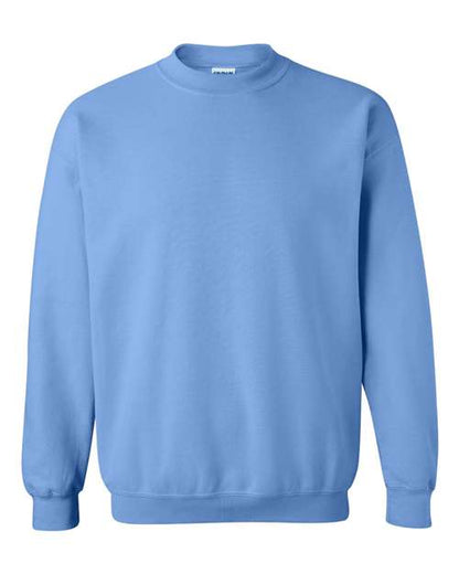 The Gildan 18000 is a plain, light blue Heavy Blend sweatshirt with long sleeves and ribbed cuffs, collar, and hem, made sustainably and shown against a white background.