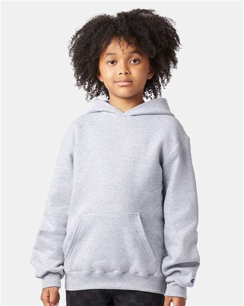 A young child with curly hair wears a Champion S790 light gray sweatshirt made from a cotton-polyester hoodie blend, standing forward with a neutral expression against a plain white background.