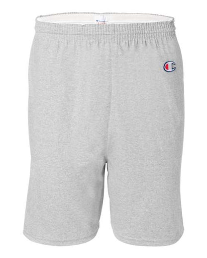 Champion 8187 athletic shorts in light gray feature an elastic waistband and an embroidered logo on the left thigh. Made from 100% cotton, they offer a simple, comfortable design with no visible pockets or patterns.
