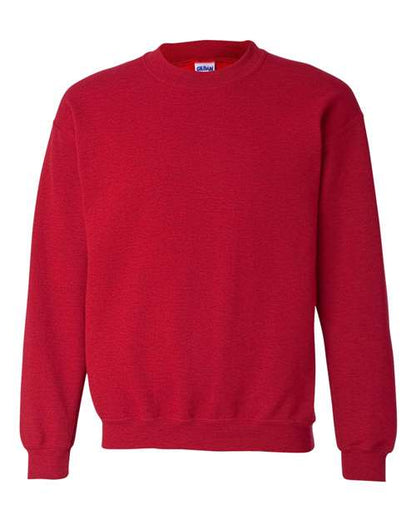 The Gildan 18000 is a plain red Heavy Blend sweatshirt with long sleeves, ribbed cuffs, hem, and neckline. OEKO-TEX certified for safety, it is displayed against a white background.