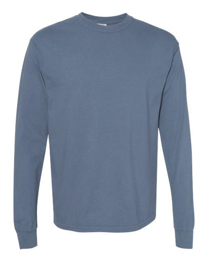 The Comfort Colors 6014 is a plain, long-sleeve, crew neck t-shirt in muted blue, shown on a white background. Made from soft ring spun cotton, it features no visible designs, logos, or patterns.