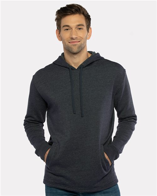 A man smiles at the camera, wearing the Next Level 9300 dark gray cotton-polyester fleece hoodie with drawstrings and a front pocket—a perfect blend of comfort and style.