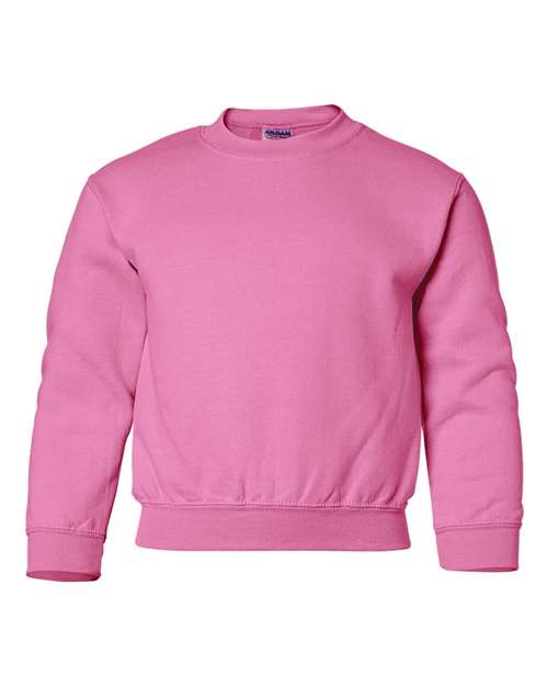 The Gildan 18000B is a solid pink, long-sleeved crewneck sweatshirt made with Heavy Blend fabric, shown on a white background.