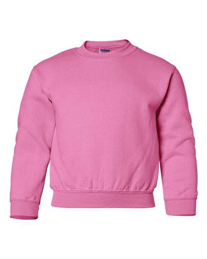 The Gildan 18000B is a solid pink, long-sleeved crewneck sweatshirt made with Heavy Blend fabric, shown on a white background.