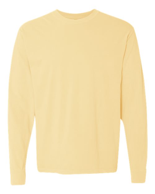 The Comfort Colors 6014 is a plain, long-sleeve t-shirt in light yellow, made from soft ring spun cotton. It features a classic crew neckline and has no visible patterns, logos, or designs. Displayed on a white background.