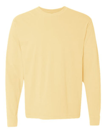 The Comfort Colors 6014 is a plain, long-sleeve t-shirt in light yellow, made from soft ring spun cotton. It features a classic crew neckline and has no visible patterns, logos, or designs. Displayed on a white background.