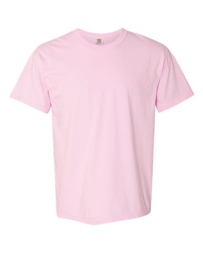 The Comfort Colors 1717 is a plain light pink short-sleeve garment-dyed t-shirt made from sustainable cotton, shown on a white background.