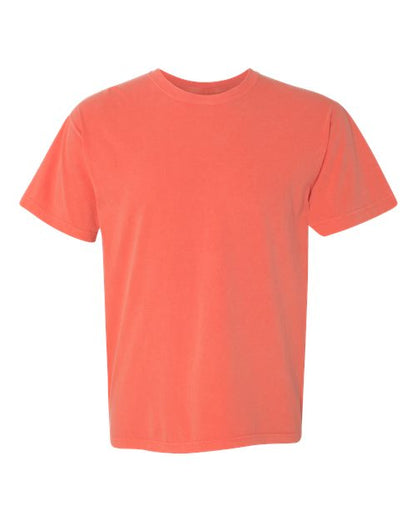 The Comfort Colors 1717 is a plain coral-colored, garment-dyed t-shirt made from sustainable cotton, shown on a white background.