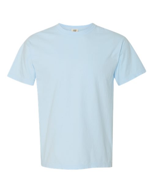 The Comfort Colors 1717 is a plain light blue short-sleeve garment-dyed t-shirt with a classic crew neck, made from sustainable cotton and featuring no visible logos or designs, shown against a white background.