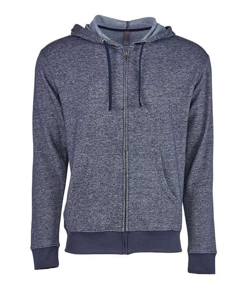 The Next Level 9600 is a heathered navy zip-up hoodie in cotton-poly blend with an antique brass YKK zipper, drawstring hood, front pockets, and ribbed cuffs and hem, shown on a plain white background.