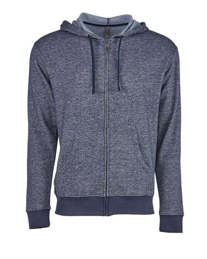 The Next Level 9600 is a heathered navy zip-up hoodie in cotton-poly blend with an antique brass YKK zipper, drawstring hood, front pockets, and ribbed cuffs and hem, shown on a plain white background.