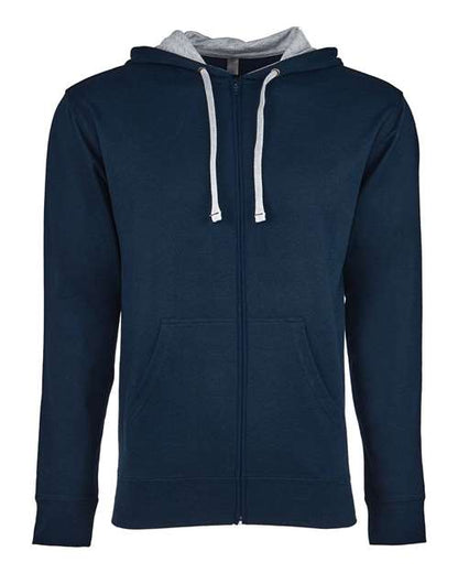 The Next Level 9601 hoodie features a dark blue cotton-polyester blend, light gray hood lining, white drawstrings, two front pockets, and a tear-away label. Shown on a plain white background.