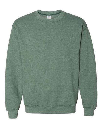 A muted green Gildan 18000 Heavy Blend sweatshirt with long sleeves and crew neck, shown on a white background. Features ribbed cuffs, collar, and hem, and is made with sustainable manufacturing for lasting comfort.