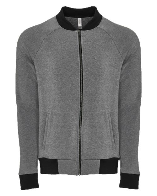 The Next Level 9700 is a gray zip-up bomber jacket in heathered fleece with black collar, cuffs, and waistband. It features an exposed YKK zipper, two front pockets, and long raglan sleeves for a modern look.