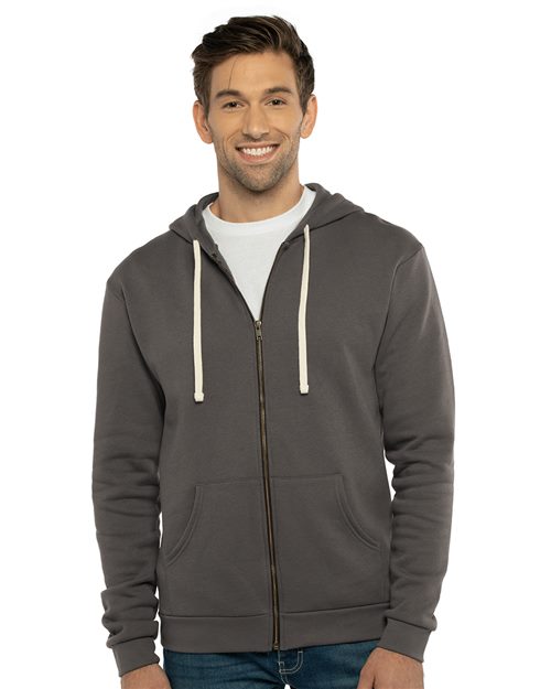 A smiling man wears the Next Level 9602 dark gray cotton hoodie with white drawstrings over a white t-shirt—a comfortable, sustainable, and socially conscious choice.
