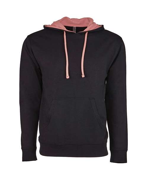 The Next Level 9301 is a black pullover hoodie in soft French terry fleece, featuring a front pocket, pink hood lining, and matching drawstrings, shown on a plain white background.