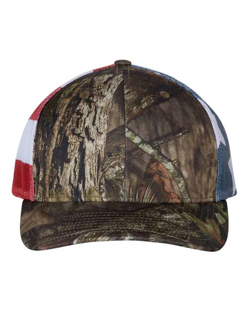 The Richardson 112PM by Richardson features a green camo front and an American flag-inspired mesh back in red, white, and blue. It offers an adjustable snapback closure for a perfect fit and eco-friendly style.