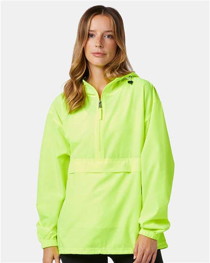 A woman with long, light brown hair wears a neon yellow-green Champion CO200 micro poplin pullover jacket with a front zipper and elastic cuffs, standing against a plain light gray background.