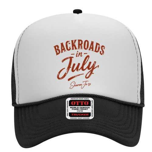 A black and white hat from DB Custom Creations, featuring "Backroads in July Shanna Jo" in brown cursive on the front panel. Product name: Black and White Hat Back Roads.