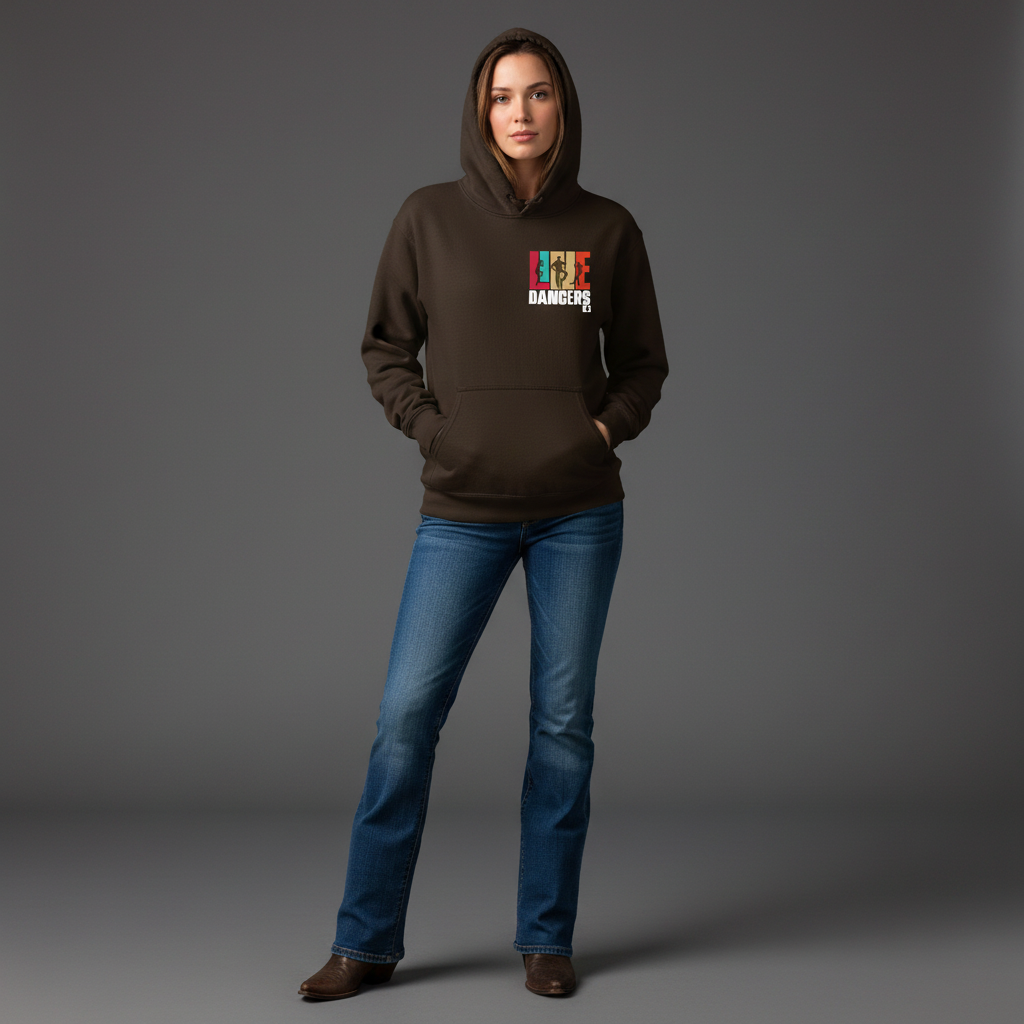 A woman faces forward with her hands in the pockets of a Gildan Brown Hoodie 18500 by DB Custom Creations, featuring a colorful DANGER graphic. She pairs it with blue jeans and brown boots against a plain gray background.