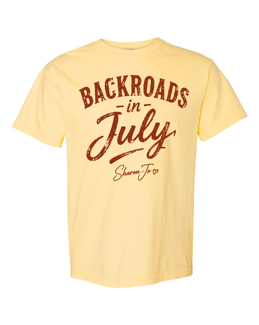 A light yellow "Backroads in July" T-shirt by DB Custom Creations, featuring "Sharon Jo" in bold brown script on the front.