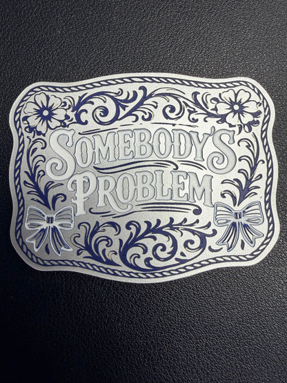 DB Custom Creations' custom laser engraved tri layered acrylic patches for hats showcase bold floral designs, bows, ornate borders, and the phrase "Somebody’s Problem," set on a textured black base with strong adhesive for secure use.