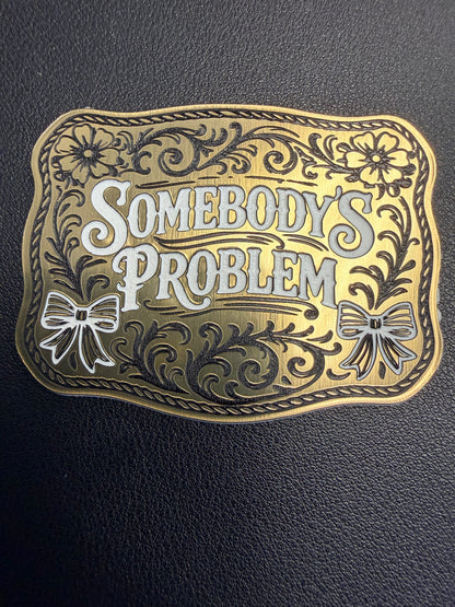 DB Custom Creations' Custom Laser Engraved Tri Layered Acrylic Patch features floral patterns, two bows, and "Somebodys Problem" text. Crafted like luxury patches, it stands out against a textured black background. Perfect for hats.