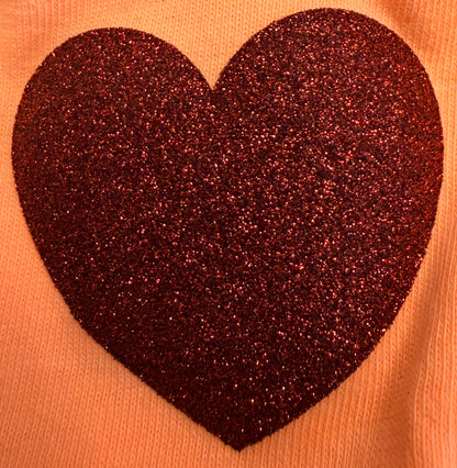 A bold, dark red glittery heart design is prominently featured on a light pink fabric background, making DB Custom Creations' Custom Puff Transfers for T-Shirts and Apparel an attention-grabbing option.