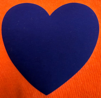 A striking design for t-shirts and apparel from DB Custom Creations’ Custom Puff Transfers features a large, solid blue heart centered on an orange textured background.