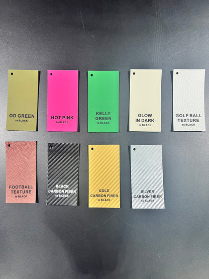 Ten rectangular color and texture sample cards for DB Custom Creations’ Custom Order Laser Engraved Patches are displayed in two rows on a black surface, each labeled with names such as OD Green, Hot Pink, Kelly Green, Glow in Dark, and more.
