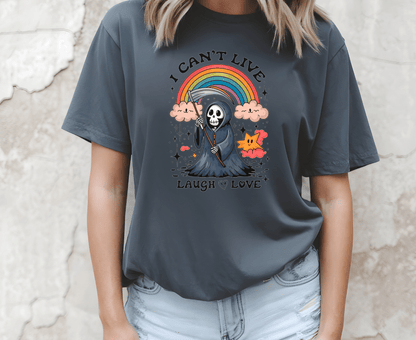 A woman wears a dark gray DB Custom Creations t-shirt called I cant live laugh love, featuring a colorful cartoon grim reaper, rainbow, clouds, and the text “I CAN’T LIVE LAUGH LOVE.”.