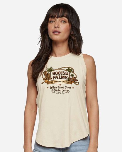 A woman with long dark hair wears the DB Custom Creations Ladies LAT-3592 Boots and Palms relaxed tank, featuring a “Boots & Palms Line Dancing Cozumel” logo with boots, a cowboy hat, palm trees, and the phrase “Where Boots Scoot & Palms Sway.”.
