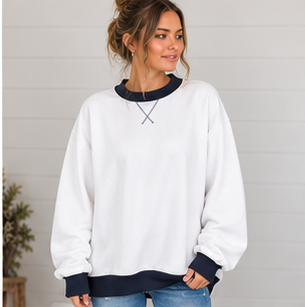 A woman wears a white DB Custom Creations Oversized Mock Neck sweatshirt featuring a dark navy collar, hem, and cuffs, crafted from premium fabric with a cross-stitch detail at the neckline.