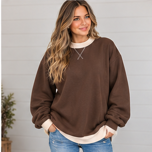 A person wearing a brown DB Custom Creations Oversized Mock Neck with a cream-colored hem, designed for premium everyday wear.