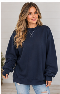 A woman wears a navy blue Oversized Mock Neck sweatshirt featuring cross-stitching at the collar and premium fabric.