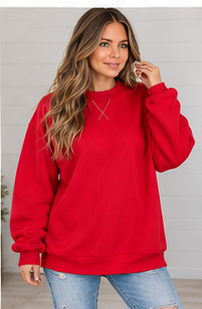 A woman wearing a red Oversized Mock Neck sweatshirt with an oversized fit and mock neck collar, crafted from premium fabric.
